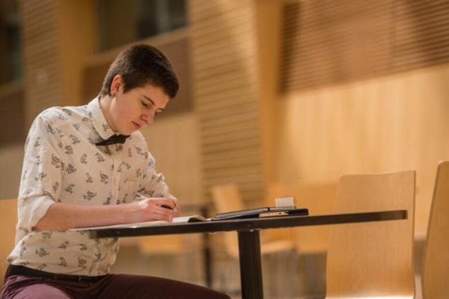 Student studying in the life sciences building atrium