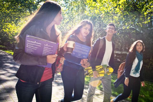 Students chatting while walking in the campus.