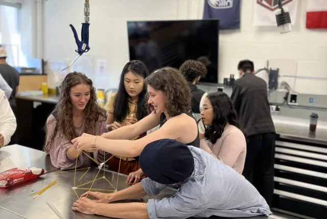 Five students working together on a project.