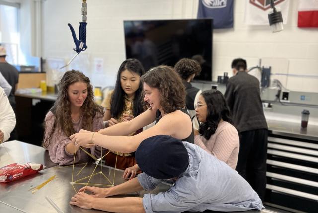 Five students working together on a project.