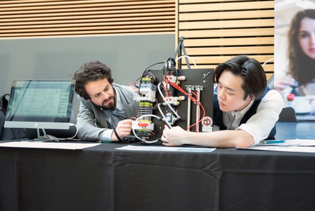 Two students demonstrating their project