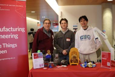Students and faculty at the booth