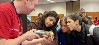 Students looking at a prototype