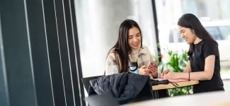 Two students discussing at the table