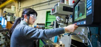 Female students working with a machine