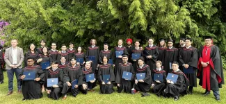 Students taking group photo in their graduation regalia