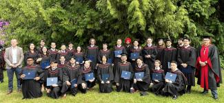 Students taking group photo in their graduation regalia