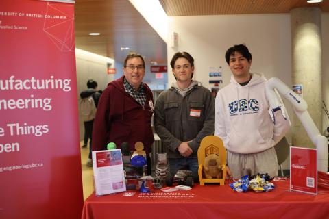Students and faculty at the booth