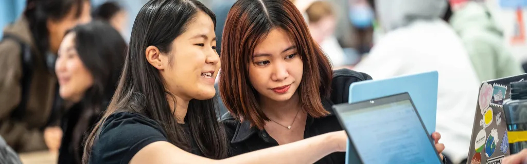 Two students chatting about the assignment
